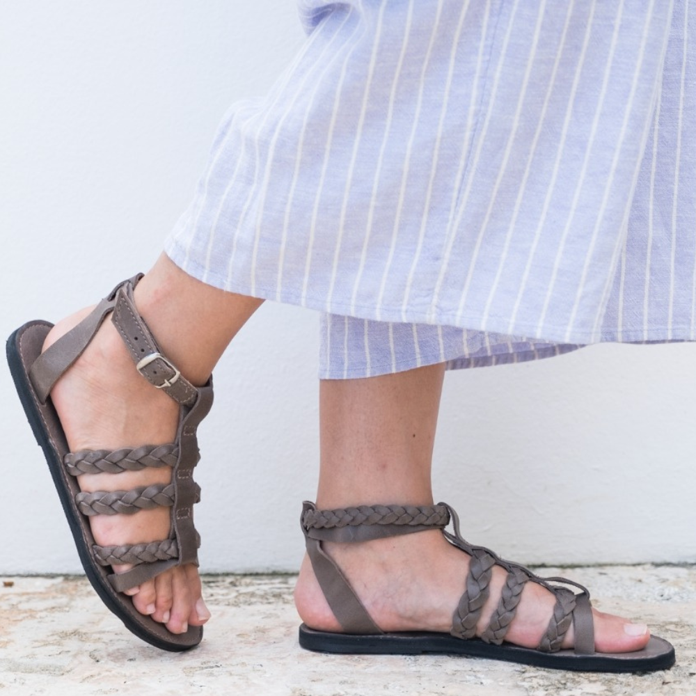 The Kaitlin Gladiator Leather Sandal featuring handcrafted braided leather straps and upcycled tire soles for comfort and style