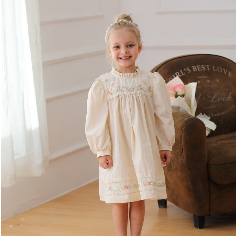Apricot cotton girls ruffle neck long sleeves dress with floral embroidery for autumn and spring, worn by a smiling girl