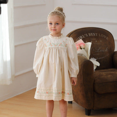 Baby girl wearing apricot cotton embroidered long sleeve dress with ruffle neck, perfect for autumn and spring seasons