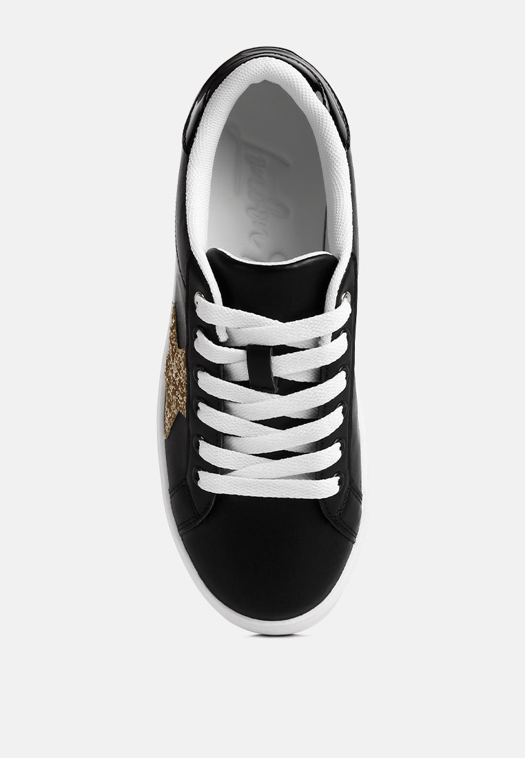 Black chunky flatform sneakers with white laces and glitter gold star detail on side