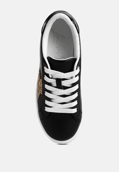 Black chunky flatform sneakers with white laces and glitter gold star detail on side